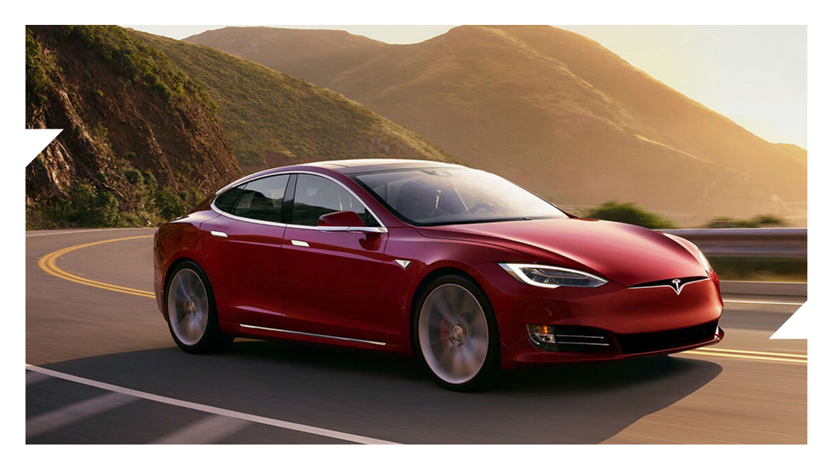 Red Tesla with a hilly background